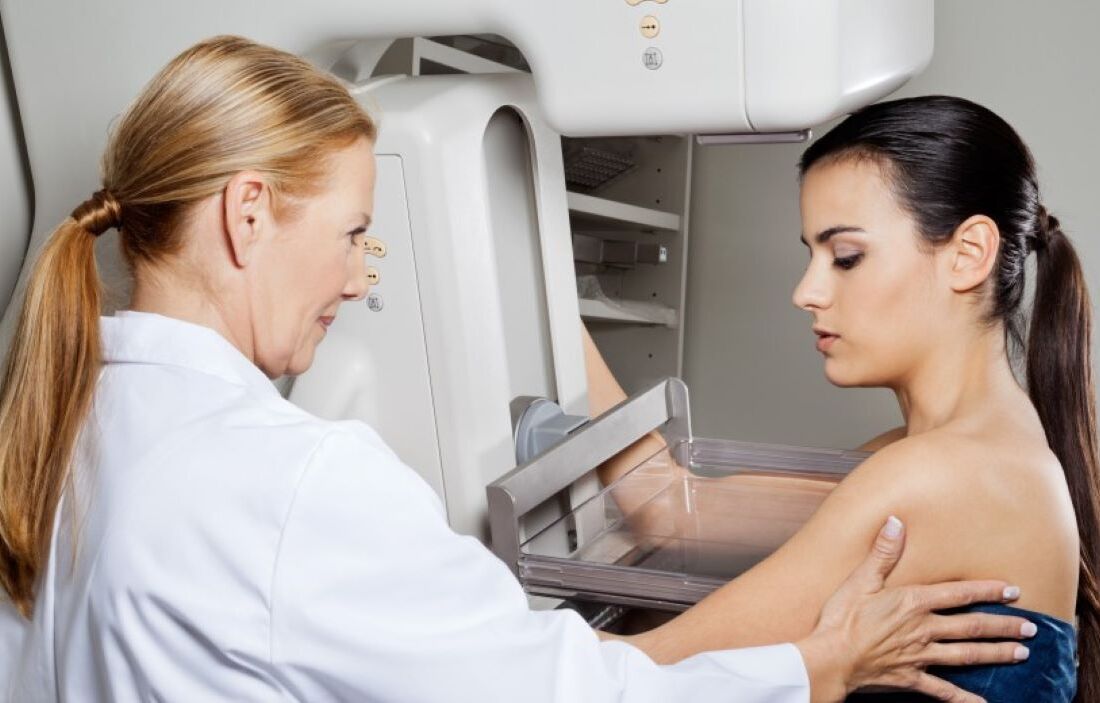 Doctor comforting patient as she has procedure done