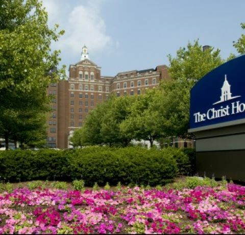 Flowers in front of The Christ Hospital sign and building
